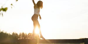 woman walking on fence