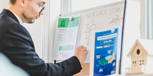 a man writing on white board