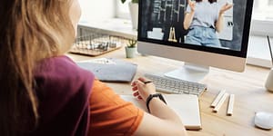 photo of girl watching through imac
