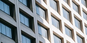glass windows on modern building reflecting sunlight