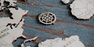 compass rose on a wooden world map
